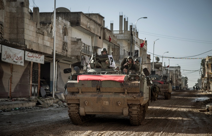 Turkish army's armored vehicles and tanks drive in Syrian town of Kobani, Feb 22, 2015